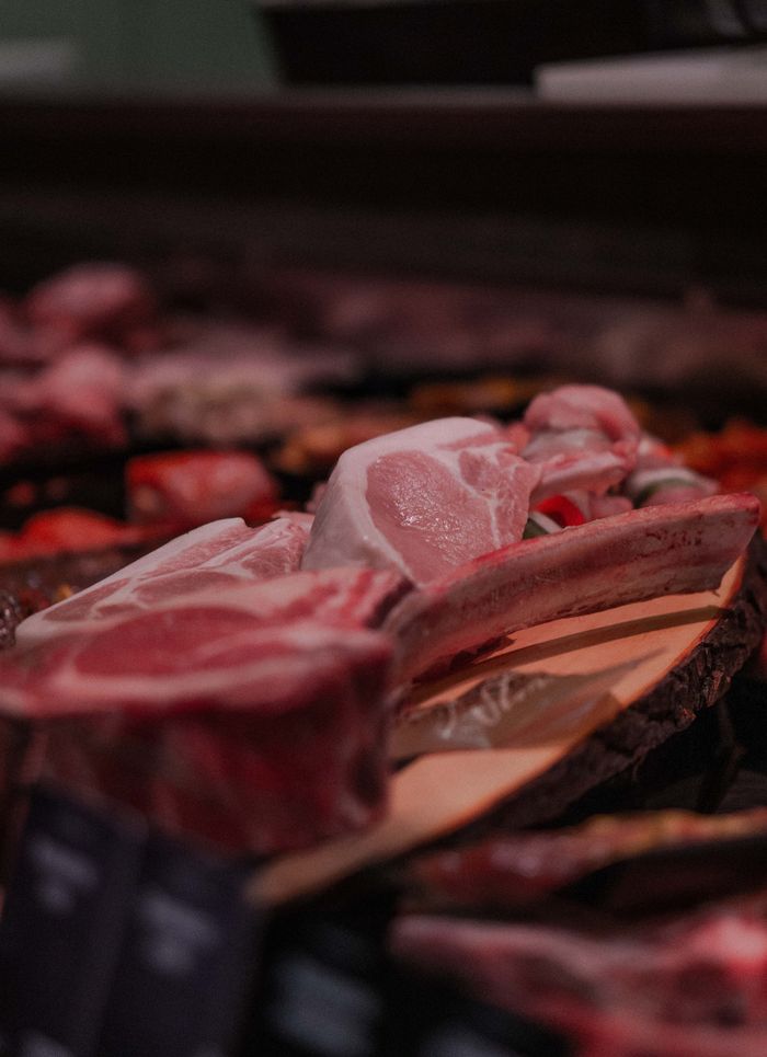 services-02 A variety of fresh raw meats on display at a stall in Stralsund market, Germany.